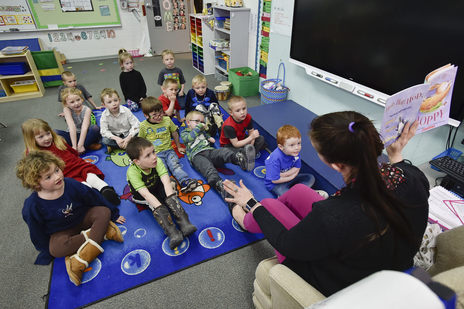 Pre-K teacher Kate Johnson reads a book to her students